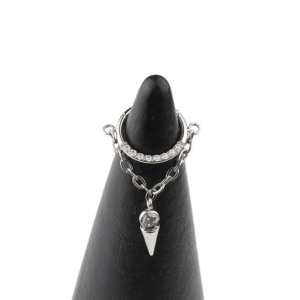 Close-up of the Nyx Dangle Clicker, a titanium 16g (1.2mm) hinged ring with an 8mm inner diameter, featuring front-facing jewels and a delicate surgical steel dangle.