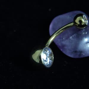 Silver titanium belly ring with clear jewel, 14-gauge thickness, and 4mm and 8mm ball ends