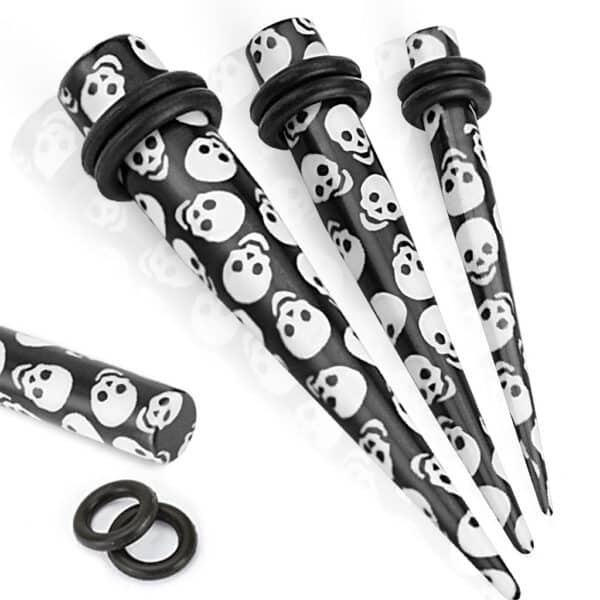 Black solid acrylic taper with printed skulls and black O-rings in 8GA and 6GA