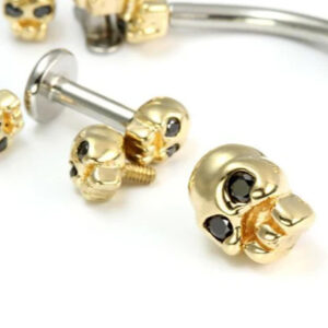 14kt gold skull labret with black gem eyes and titanium post